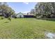 Well-maintained backyard features ample green space and mature trees, providing a tranquil backdrop to the home at 9650 W Lake Marion Rd, Haines City, FL 33844