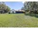 Expansive backyard featuring lush green grass and a screened-in porch, perfect for outdoor enjoyment at 9650 W Lake Marion Rd, Haines City, FL 33844