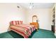 Cozy bedroom with green carpet and a comfortable bed with dresser at 9650 W Lake Marion Rd, Haines City, FL 33844