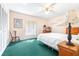 Cozy bedroom featuring natural light, a side table with lamp, built-in shelving, and an overhead fan at 9650 W Lake Marion Rd, Haines City, FL 33844