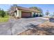 Charming home exterior with spacious driveway and lush landscaping, including a lake view at 9650 W Lake Marion Rd, Haines City, FL 33844