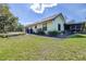 Exterior view of the home showcasing the well-maintained lawn and screened patio at 9650 W Lake Marion Rd, Haines City, FL 33844