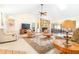 Spacious living room featuring a stone fireplace, ceiling fan, and skylight at 9650 W Lake Marion Rd, Haines City, FL 33844