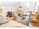 Bright living room with a stone fireplace, vaulted ceilings, and tiled flooring at 9650 W Lake Marion Rd, Haines City, FL 33844