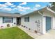 House exterior showcasing a walkway to the entrance and a blue garage door at 1521 Oakview Se Cir, Winter Haven, FL 33880