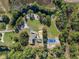 Aerial view of property with home, pool, and court at 222 Rod Ln, Davenport, FL 33837