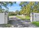 Long driveway leading to home with gated entrance at 222 Rod Ln, Davenport, FL 33837