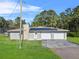 House exterior with solar panels and a two-car garage at 222 Rod Ln, Davenport, FL 33837