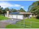 House exterior with three-car garage and solar panels at 222 Rod Ln, Davenport, FL 33837