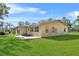 Back exterior view of the home with patio at 222 Rod Ln, Davenport, FL 33837