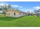 Side view of house with large grassy area at 222 Rod Ln, Davenport, FL 33837