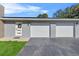 Three-car garage with modern white doors at 222 Rod Ln, Davenport, FL 33837