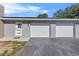 Two-car garage with modern doors and a gray exterior at 222 Rod Ln, Davenport, FL 33837