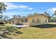 Ranch-style home with covered patio and yard at 222 Rod Ln, Davenport, FL 33837