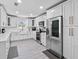 Renovated kitchen, featuring stainless steel appliances and white shaker cabinets at 222 Rod Ln, Davenport, FL 33837