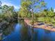 Serene pond view, reflecting the surrounding trees at 222 Rod Ln, Davenport, FL 33837