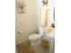 Small bathroom with white toilet and sink, yellow accents at 605 Sarner Pass Way, Winter Haven, FL 33881