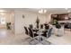 Bright dining area with glass table and black chairs, adjacent to kitchen at 605 Sarner Pass Way, Winter Haven, FL 33881