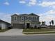 Two-story house with gray siding and a two-car garage at 605 Sarner Pass Way, Winter Haven, FL 33881