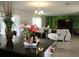 Kitchen island with granite countertop, offering a view into the spacious living area at 605 Sarner Pass Way, Winter Haven, FL 33881