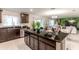 Kitchen island with granite countertop and dark wood cabinets at 605 Sarner Pass Way, Winter Haven, FL 33881