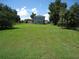 Spacious grassy backyard with a two-story house in the background at 1300 Lucerne Loop Ne Rd, Winter Haven, FL 33881