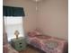 Bedroom with twin beds, nightstand, and window at 1300 Lucerne Loop Ne Rd, Winter Haven, FL 33881