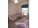 Spacious bedroom with two twin beds and window at 1300 Lucerne Loop Ne Rd, Winter Haven, FL 33881