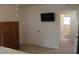 Bedroom with wooden armoire and door to bathroom at 1300 Lucerne Loop Ne Rd, Winter Haven, FL 33881