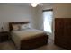 Bedroom with double bed, wooden dresser, and window at 1300 Lucerne Loop Ne Rd, Winter Haven, FL 33881