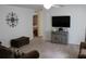 Spacious living room with a comfy couch, large TV, and neutral color scheme at 1300 Lucerne Loop Ne Rd, Winter Haven, FL 33881