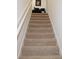 Beige carpeted staircase leading to the upper level at 1300 Lucerne Loop Ne Rd, Winter Haven, FL 33881