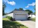 Single-story home featuring a two car garage, trimmed hedges, and a freshly cut lawn at 2158 Mirasol Dr, Winter Haven, FL 33881