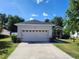 Charming single-story home with a well-manicured lawn, a two car garage, and lovely landscaping at 2158 Mirasol Dr, Winter Haven, FL 33881