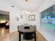 Bright dining room with a dark wood table and modern lighting fixture at 5643 Fischer Dr, Lakeland, FL 33812