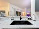 Modern kitchen with a large island, quartz countertops and black sink at 5643 Fischer Dr, Lakeland, FL 33812