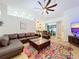 Spacious living room featuring a leather sectional sofa, large TV and colorful rug at 5643 Fischer Dr, Lakeland, FL 33812