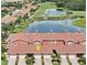 Beautiful aerial view of townhomes near a scenic pond and lush green golf course at 1202 Ashton Palms Dr # 6, Lake Wales, FL 33859