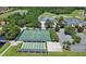 Aerial view of community tennis courts, shuffleboard, golf course, and clubhouse overlooking a lush green landscape at 1202 Ashton Palms Dr # 6, Lake Wales, FL 33859