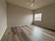 A bedroom that includes wood flooring, a ceiling fan, a window, and light grey walls at 1202 Ashton Palms Dr # 6, Lake Wales, FL 33859