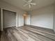 Bedroom with wood-look floors and ample closet space at 1202 Ashton Palms Dr # 6, Lake Wales, FL 33859