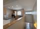 Open kitchen with stainless steel appliances and granite countertops viewed from stairs at 1202 Ashton Palms Dr # 6, Lake Wales, FL 33859