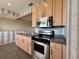 Modern kitchen boasts stainless steel oven and microwave, and light wood cabinets at 1202 Ashton Palms Dr # 6, Lake Wales, FL 33859