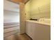 Laundry room with washer, dryer, wire rack, and view into the living space at 1202 Ashton Palms Dr # 6, Lake Wales, FL 33859