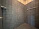 A tiled shower stall with grey tile and a built-in soap dish at 1202 Ashton Palms Dr # 6, Lake Wales, FL 33859