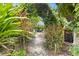 Landscaped backyard with lush tropical plants and a charming archway at 14 Pilot Pl, Winter Haven, FL 33881