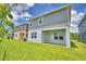 Green backyard with a covered patio at 1476 Leamington Lane, Winter Haven, FL 33884