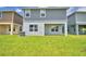 The backyard features a covered patio at 1476 Leamington Lane, Winter Haven, FL 33884