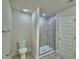 Modern bathroom featuring a stand-up shower with gray tile, a toilet, and new fixtures at 1476 Leamington Lane, Winter Haven, FL 33884