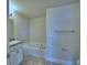 Bright bathroom features a soaking tub, granite countertops, and neutral tile flooring at 1476 Leamington Lane, Winter Haven, FL 33884
